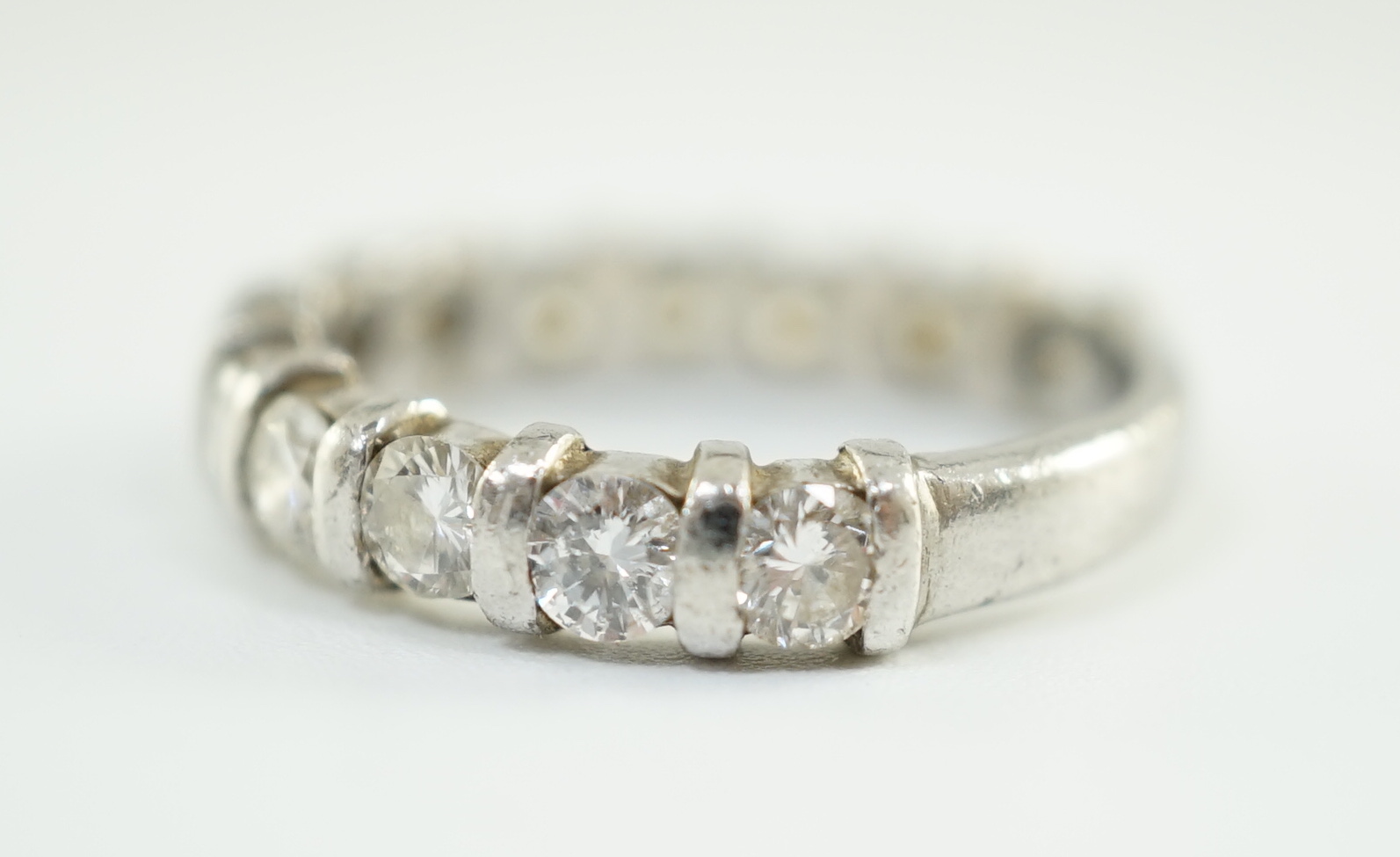 An 18ct white gold and thirteen stone round brilliant cut diamond set three quarter eternity ring